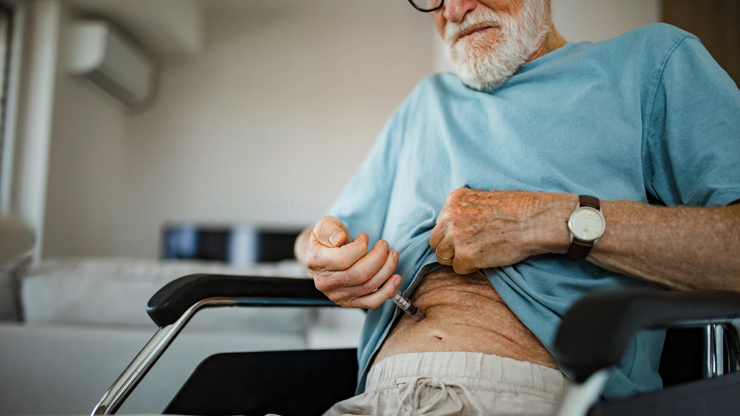 A man gives himself an injection.