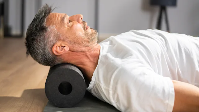 Health: Musculoskeletal: man foam roller neck 1350239815
