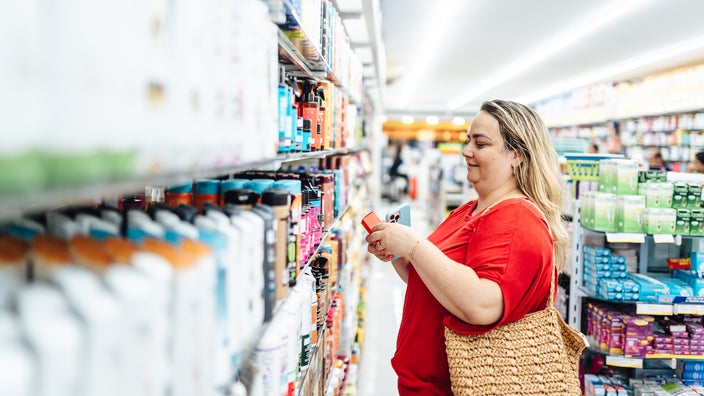 Woman shopping for supplements in a store.