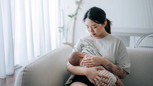 pregnancy: mother breastfeeding at home 2160835074