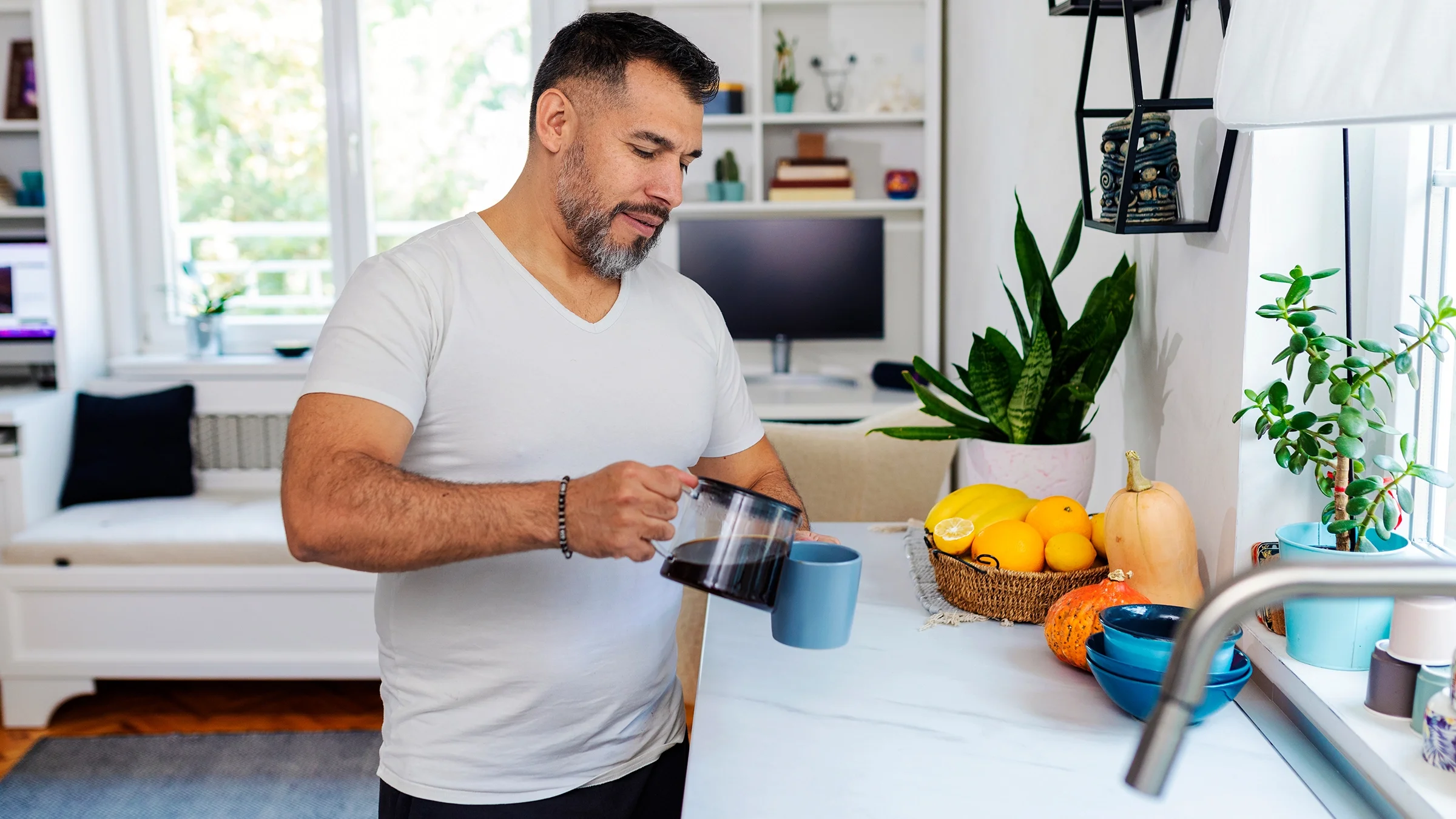 A man pours coffee into a cup.