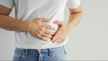 Health: Pain: closeup man holding side abdomen 1341471946