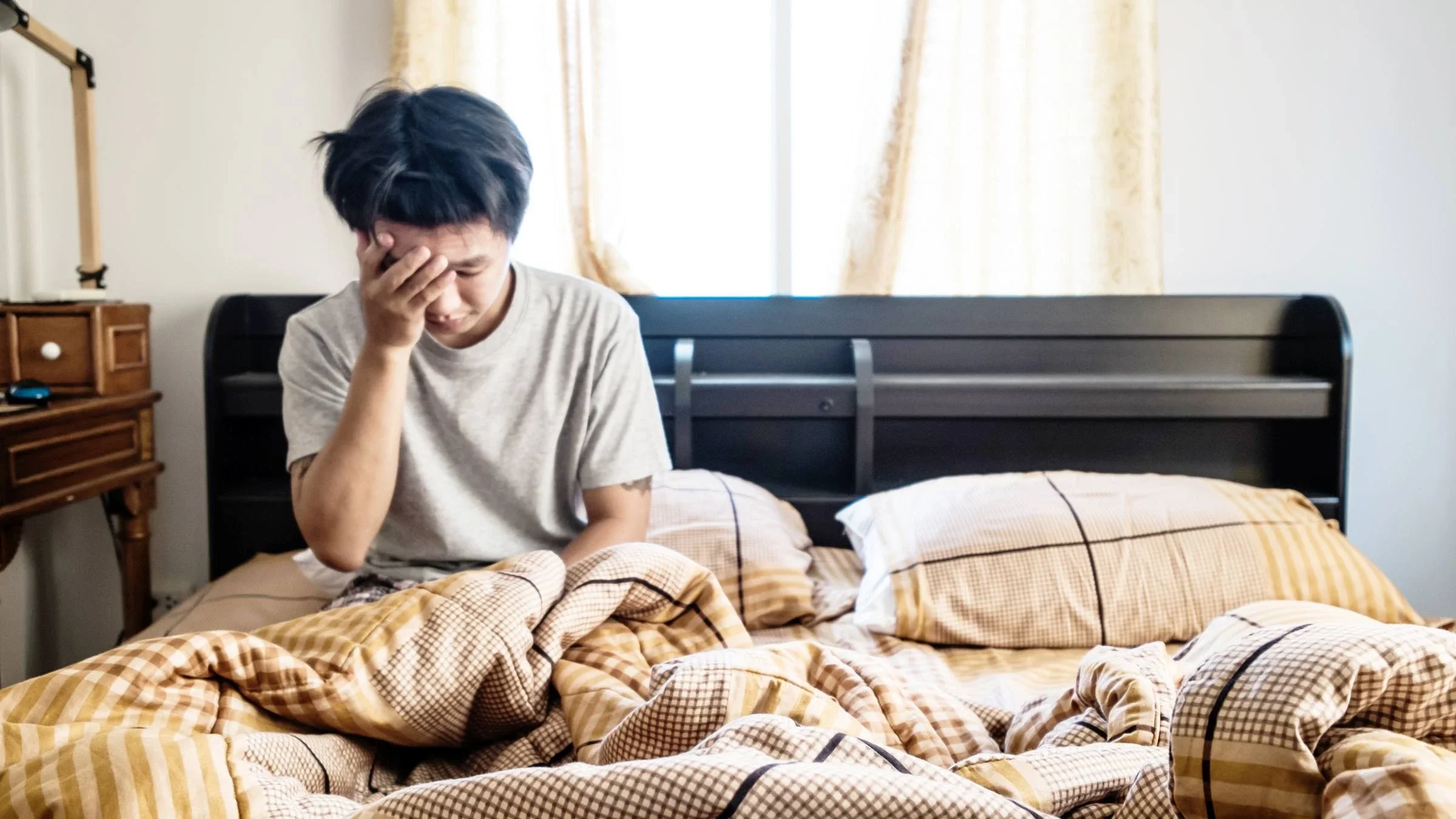 A man waking up feeling weak.