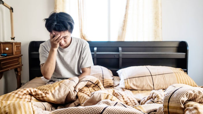 A man waking up feeling weak.