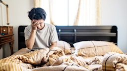 A man waking up feeling weak.
SasinParaksa/iStock via Getty Images
