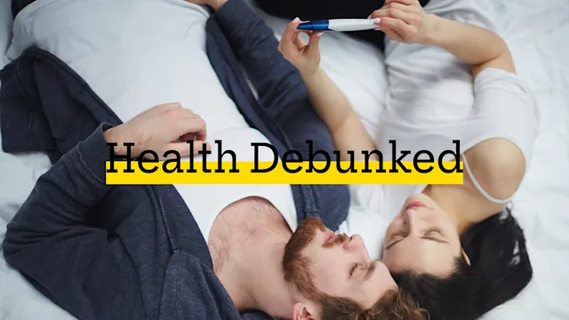 Women's health: Pregnant during period: Pregnancy test: couple in bed with pregnancy test-668575910