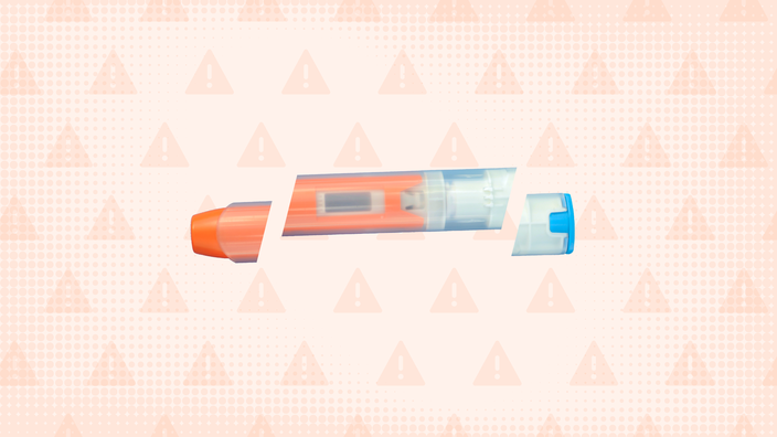 In the center of a light orange background with texture and warning sign pattern is an EpiPen cut into thirds. 