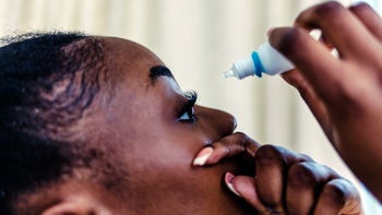Eye: closeup woman using eye drops 1441395794