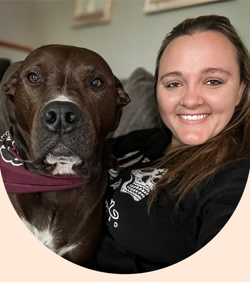 Samantha Robertson is pictured in a headshot with one of her dogs, Max.