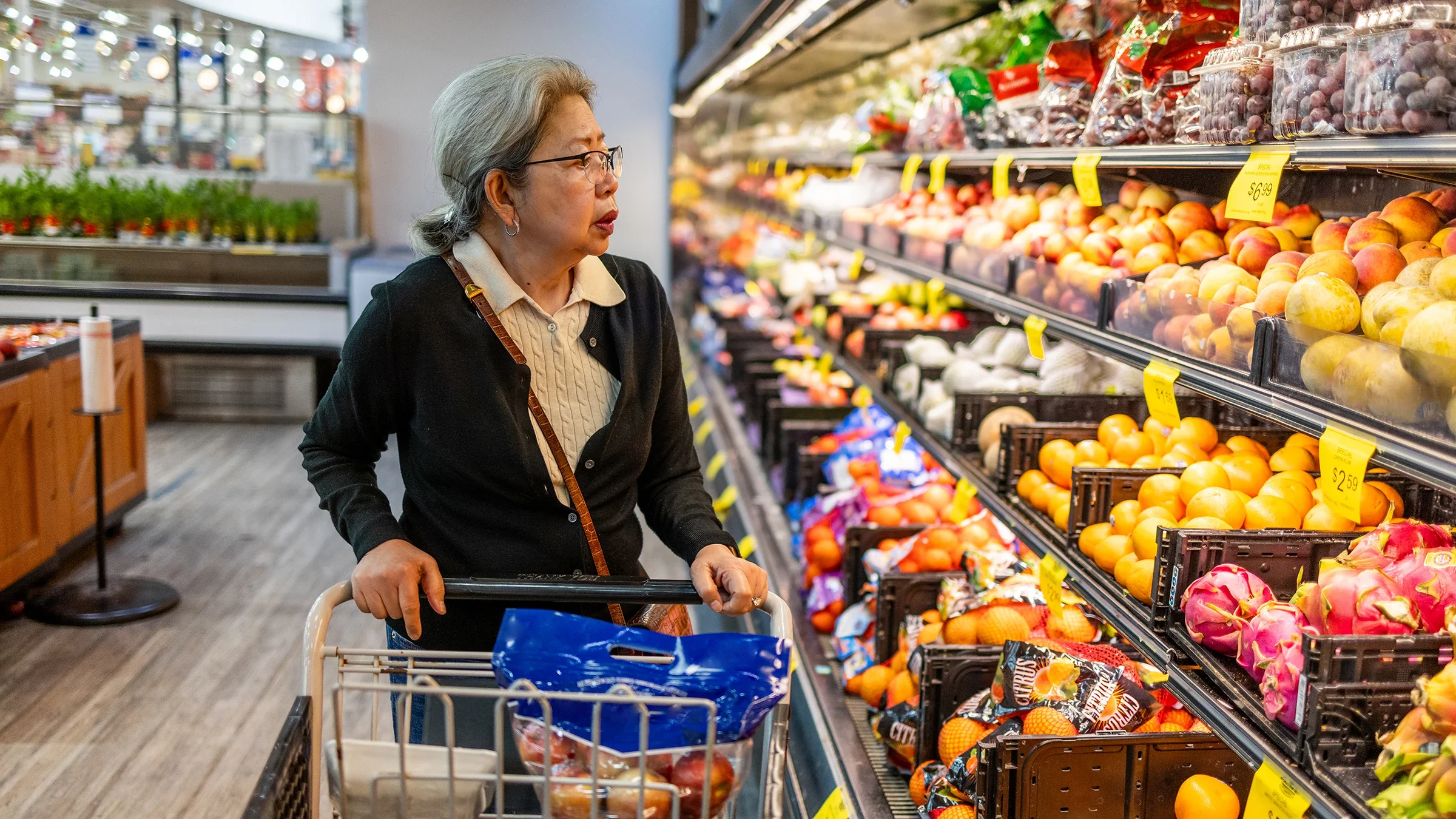A woman shops for fruit in the produce aisle.
JasonDoiy/E+ via Getty Images