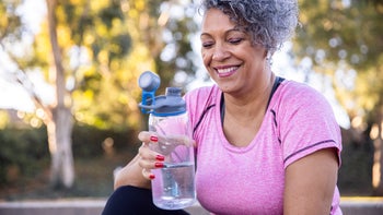 diet-nutrition: exercise: workout: senior woman drinking water after workout-1299849671