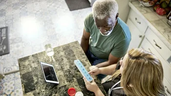 Medication Basics: caregiver organizing patient medication 1407450699