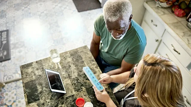 Medication Basics: caregiver organizing patient medication 1407450699