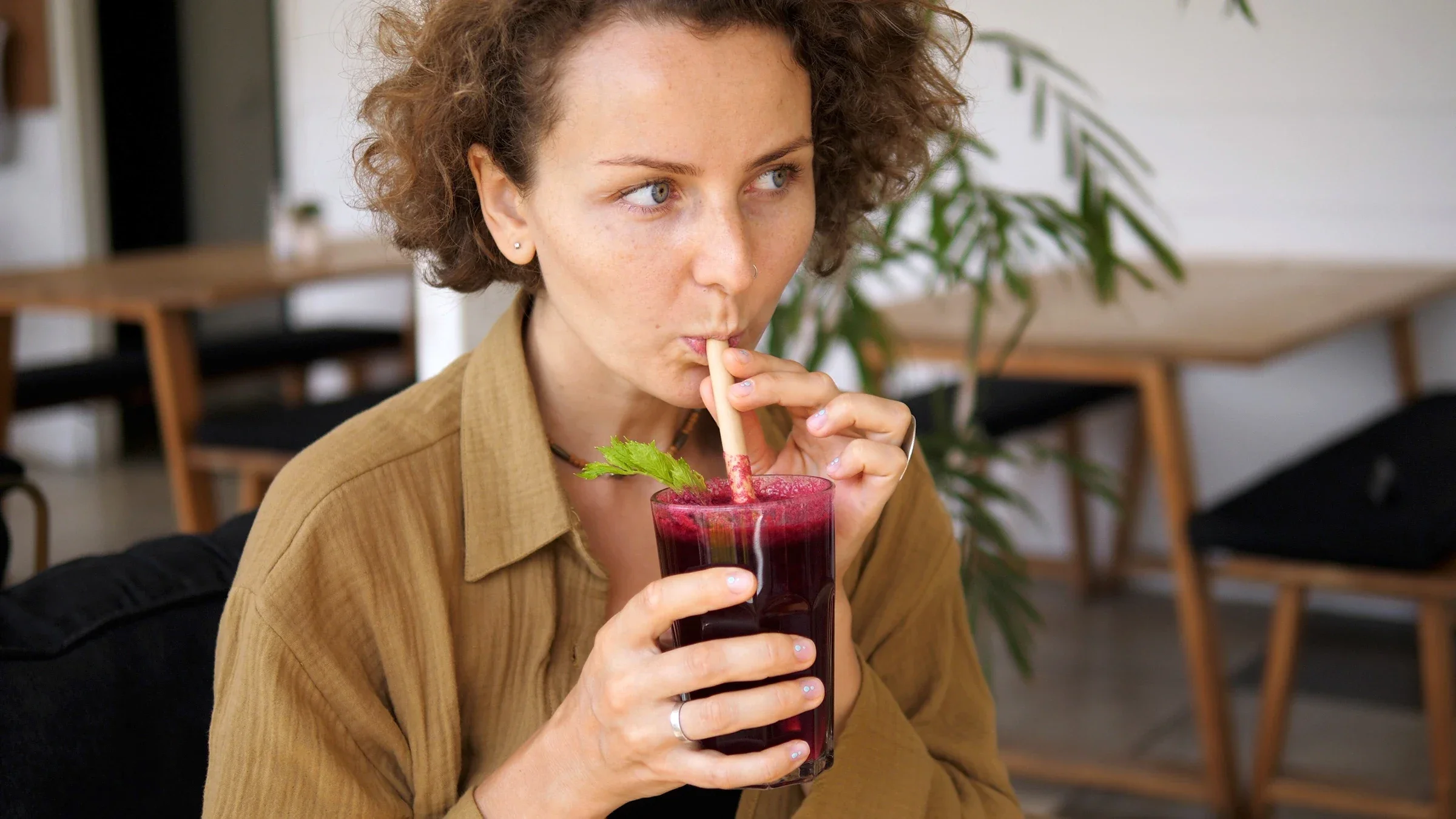 A woman drinks a glass of beet juice, which can help with kidney health.
Di_Media/iStock via Getty Images Plus 