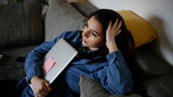 Mental Health: stressed woman holding laptop 1307785073