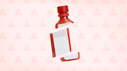 In the center of a light red background with texture and warning sign pattern is a red medicine bottle cut into thirds. 
GoodRx Health