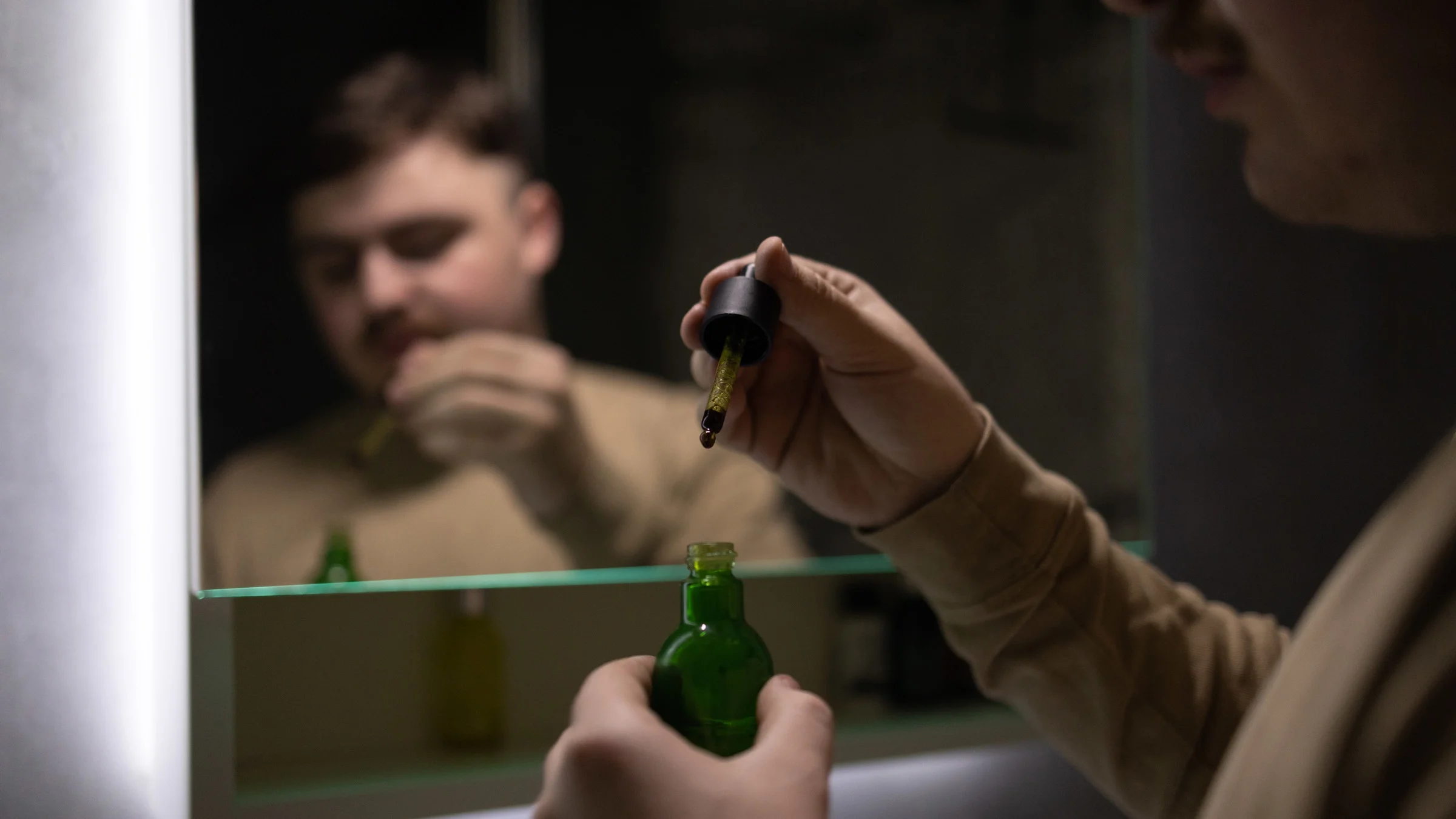A person using CBN oil in their bathroom.