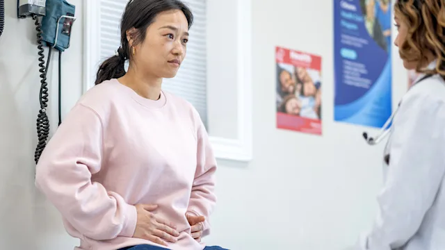 Women's Health: woman at medical appointment with abdominal pain 1491105391