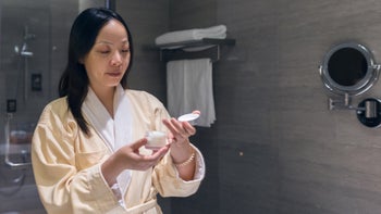 Dermatology: woman applying face cream 2165329204