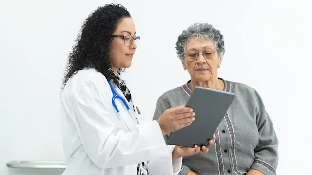 GLP 1 agonists: elderly woman speaks with young female doctor 1936230432