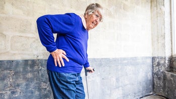 Joints: woman with hip pain using a cane 540738590