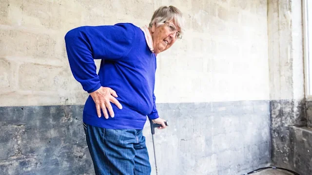Joints: woman with hip pain using a cane 540738590