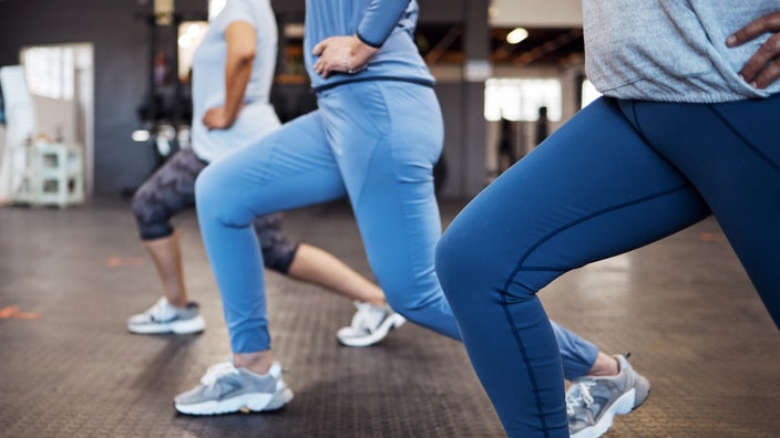 Three women perform lunges.
