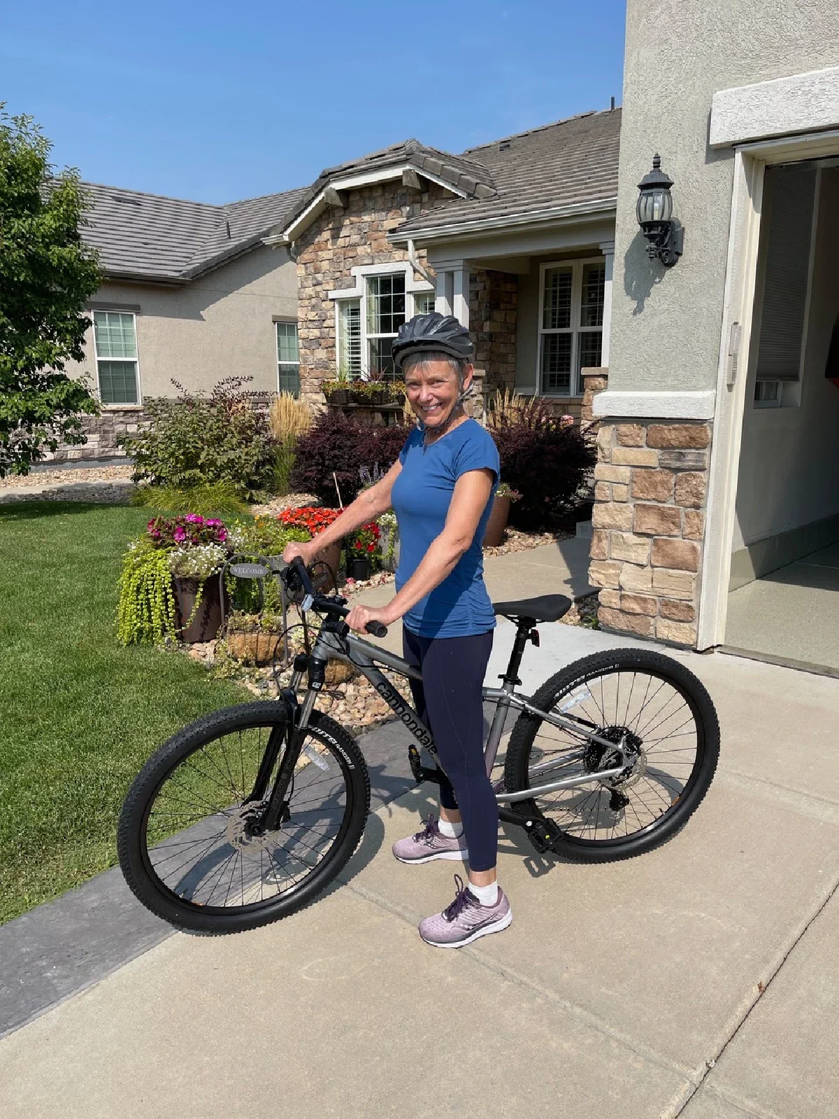 Rebecca Chopp is pictured on her bicycle in front of her house.