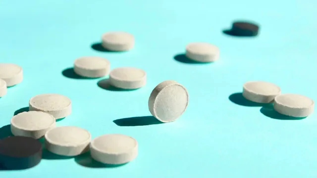 Medication Education: round pills on blue background 1477766422