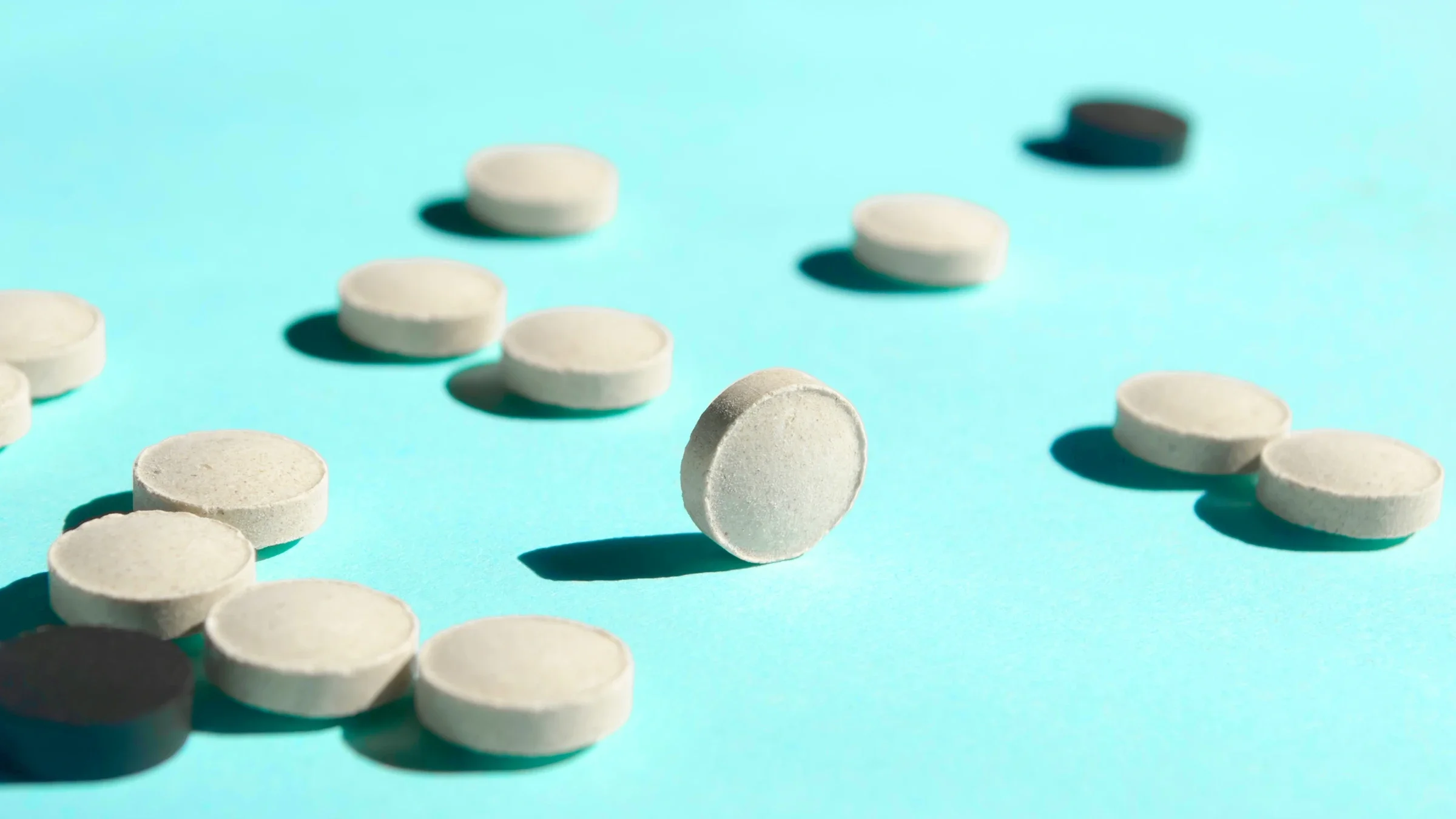White pills on a blue background.
