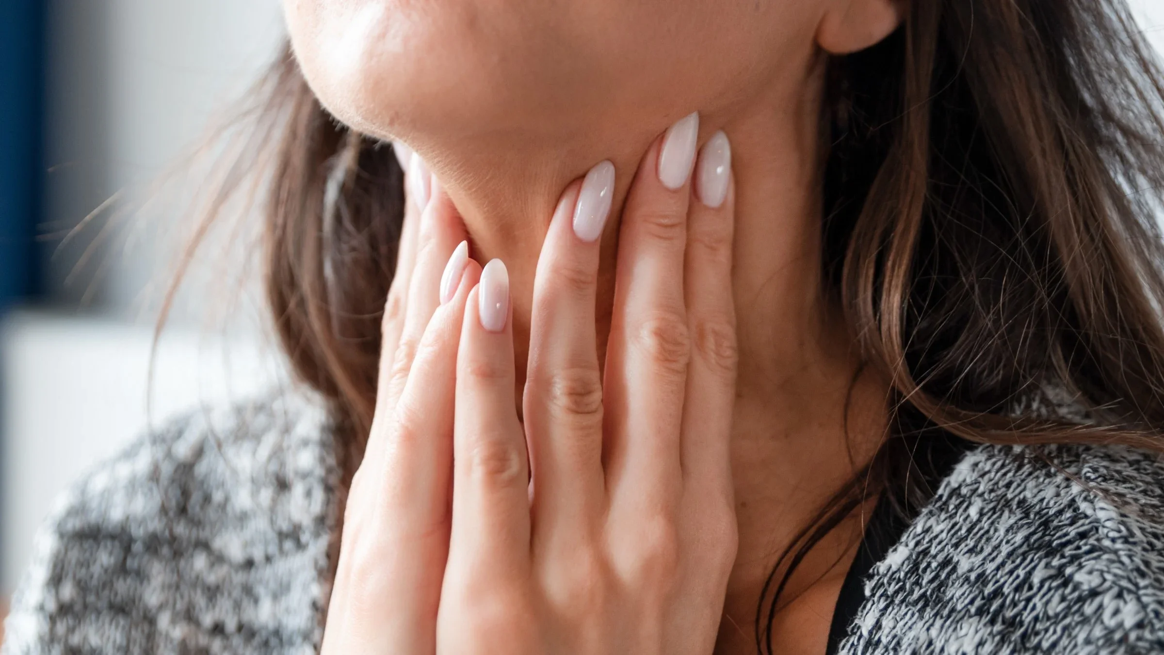 A cropped image of someone examining their own thyroid.
simpson33/iStock via Getty Images Plus  