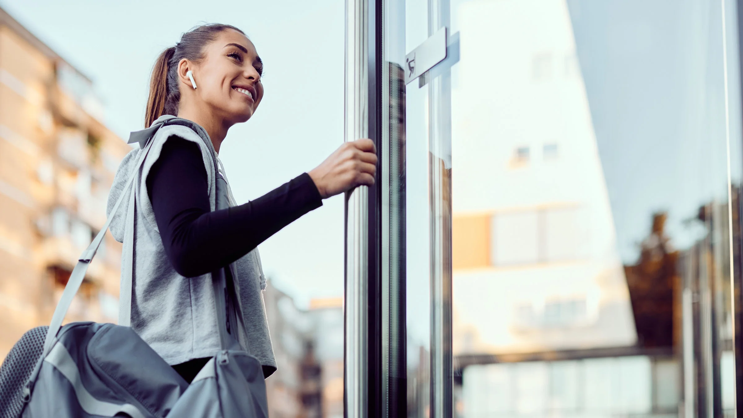 A person opening a door to enter a gym.