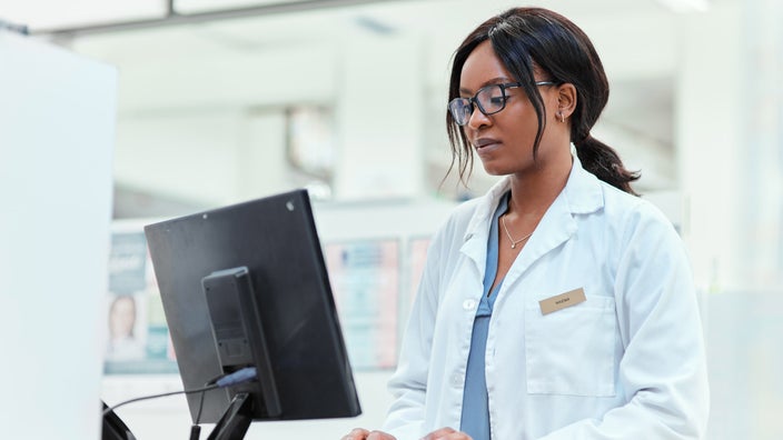 Photo of a pharmacist working at a computer