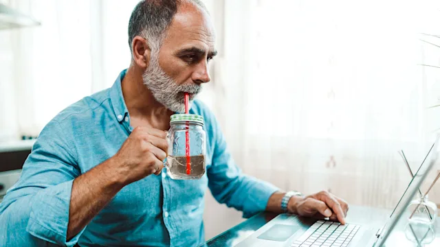magnesium citrate: man drinking through straw 1179980076