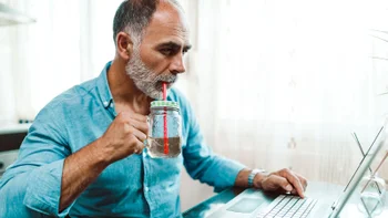 magnesium citrate: man drinking through straw 1179980076