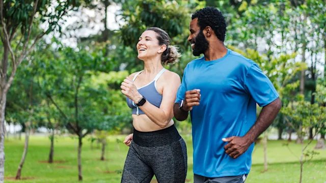 Health: Movement and exercise: couple power walking outdoors 1462659662
