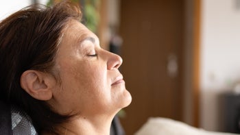depression: woman with eyes closed and head back 615206842