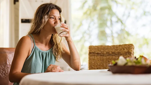 gut-health: woman drinking yogurt 1401484345