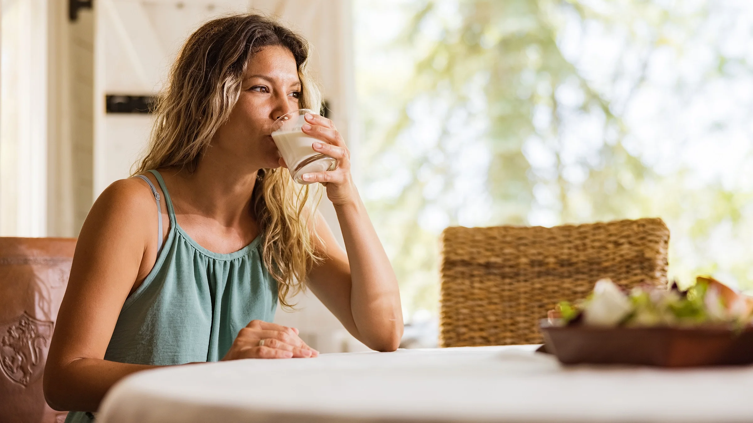 Woman sipping a drinkable yogurt