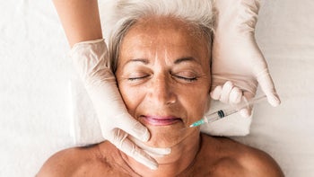 senior woman botox injection 1049778834