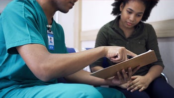 Women's Health: medical professional discussing treatment plan with patient 1388194636
