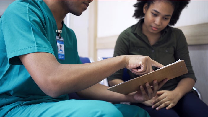 Medical professional discussing treatment plan with a patient.