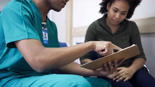 Women's Health: medical professional discussing treatment plan with patient 1388194636