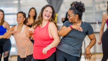 Movement exercise: two women dancing at fitness studio GettyImages-897892972