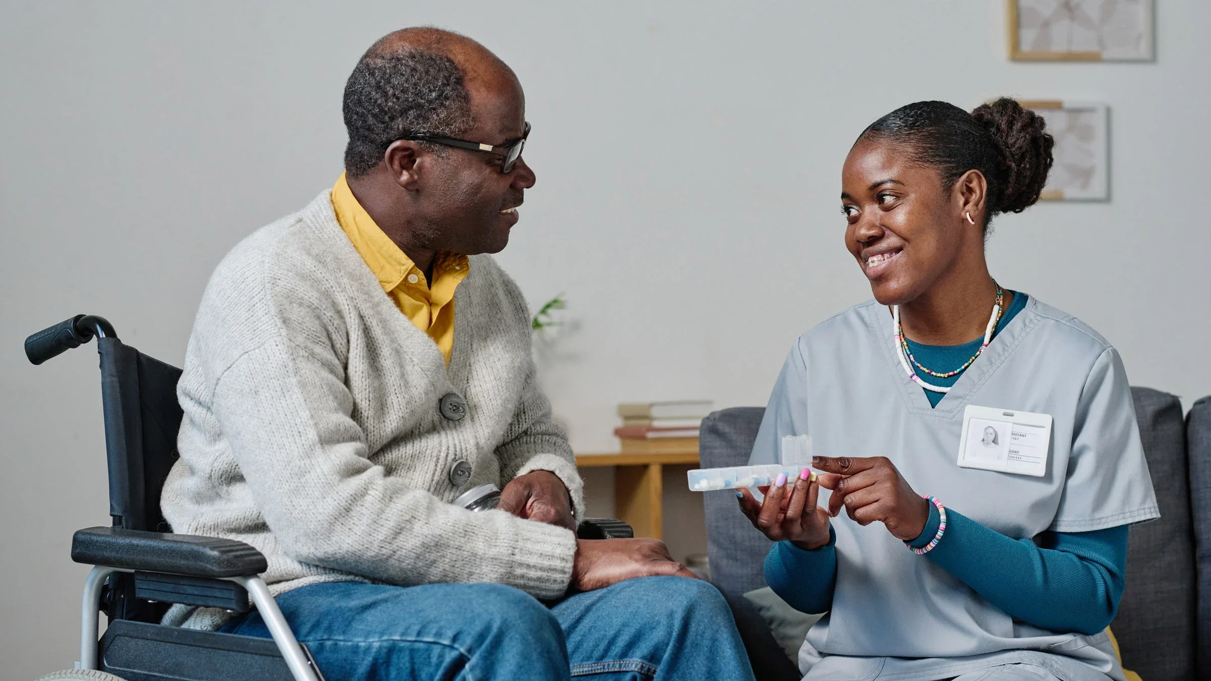 A caregiver explaining pills to a senior man.
AnnaStills/iStock via Getty Images Plus 