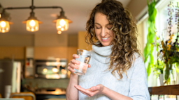 A person taking pills with water.
stockstudioX/E+ via Getty Images 