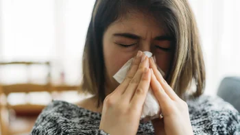 Allergic-rhinitis: woman blowing her nose 1125386303