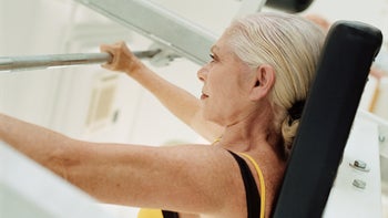 Movement and exercise: senior woman weight training gym 77276895