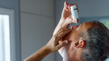 Health: Eye inflammation: man inserting eye drops 1158024520