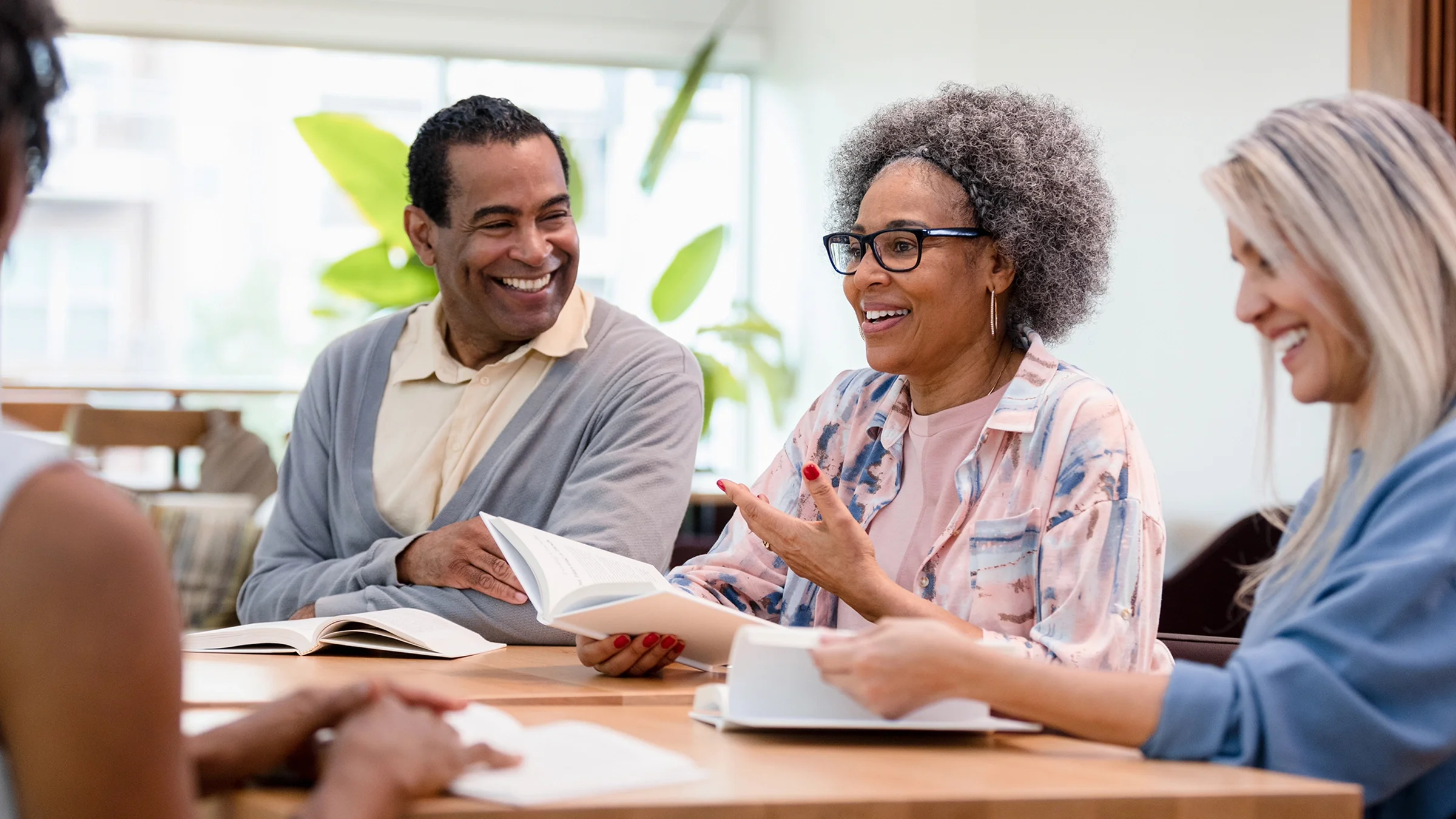 Group members have a book club discussion.